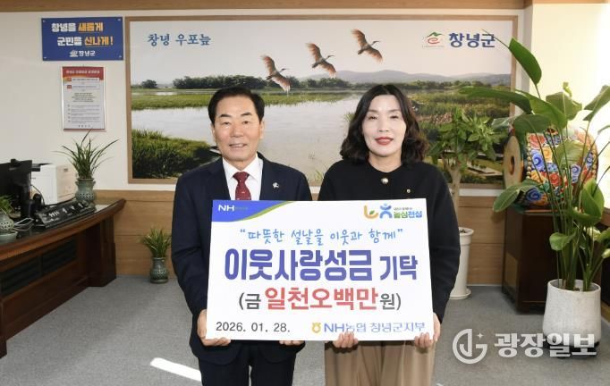 유동경 지부장이 설맞이 이웃사랑성금을 기탁하며 성낙인 군수와 기념촬영을 하고 있다.